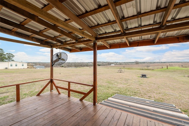 deck featuring a rural view and a lawn