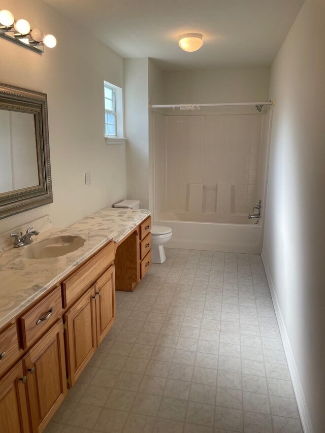 full bathroom with baseboards, toilet, tile patterned floors, vanity, and washtub / shower combination