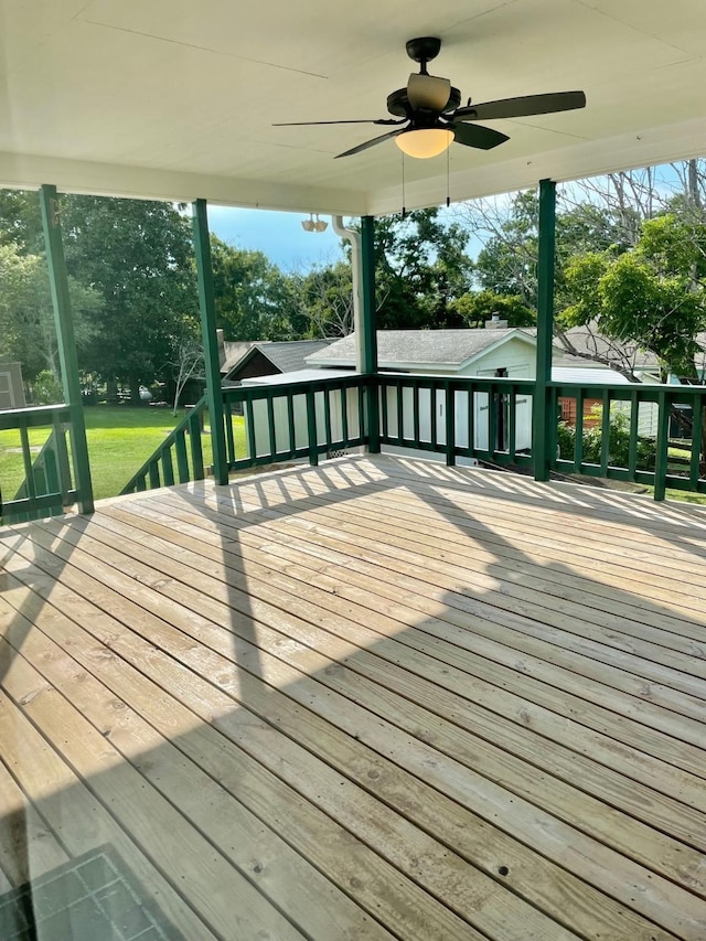 wooden deck featuring a ceiling fan