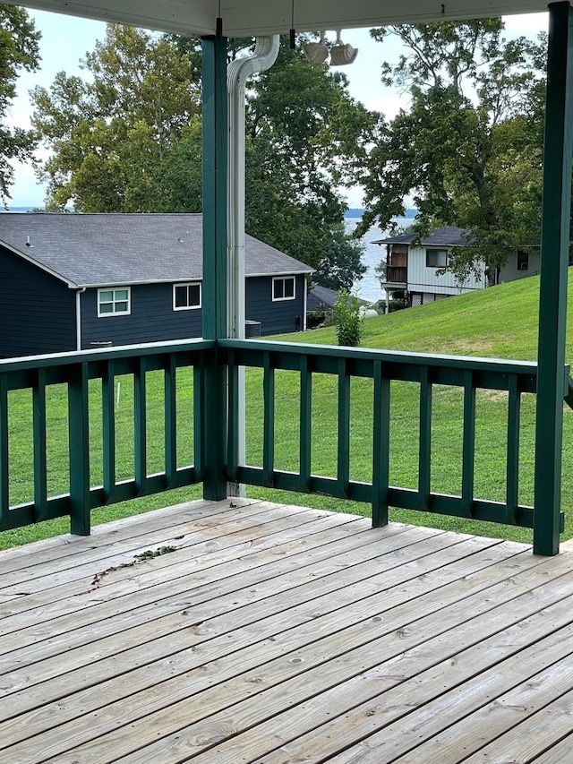 wooden deck with a lawn