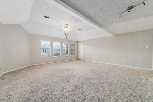 carpeted spare room featuring visible vents, ceiling fan, a textured ceiling, and baseboards