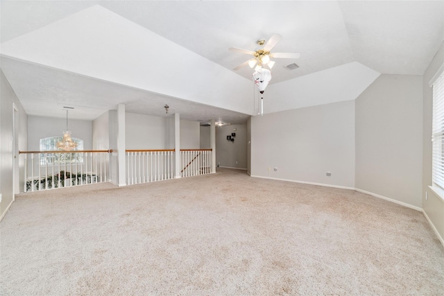 spare room with lofted ceiling, a ceiling fan, baseboards, a wealth of natural light, and carpet