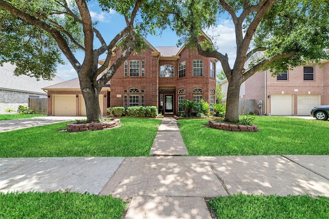 view of front of house with a garage, driveway, brick siding, and a front yard