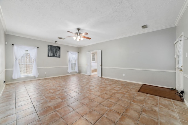 empty room featuring a textured ceiling, visible vents, a ceiling fan, and crown molding