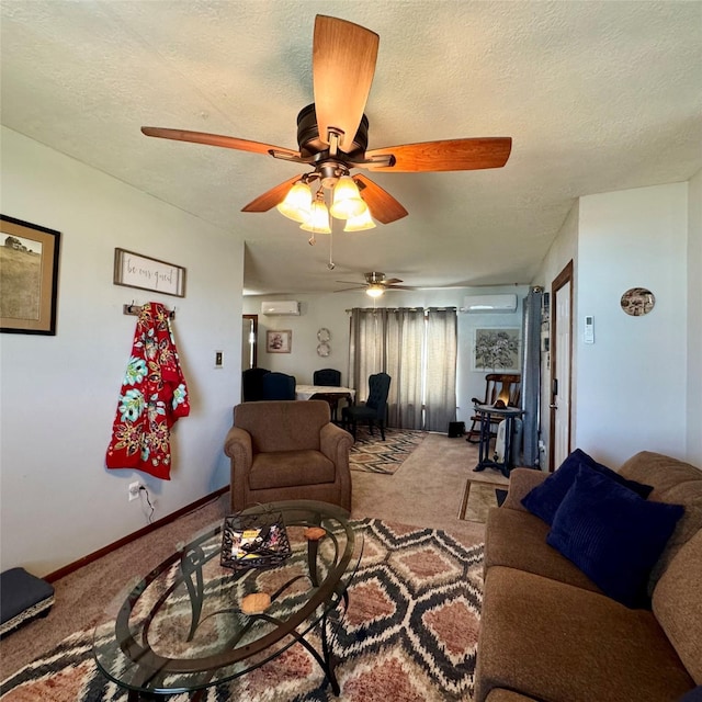 carpeted living area with a wall mounted air conditioner, ceiling fan, a textured ceiling, and baseboards