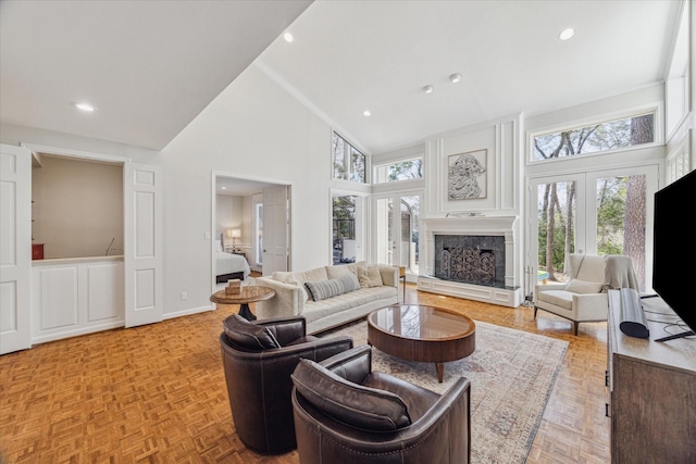 living area with high vaulted ceiling, french doors, a fireplace, and recessed lighting