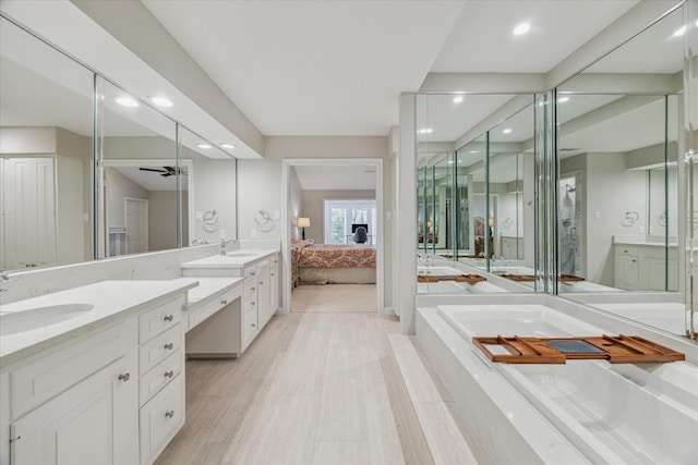 full bathroom featuring ensuite bath, ceiling fan, vanity, a bath, and recessed lighting