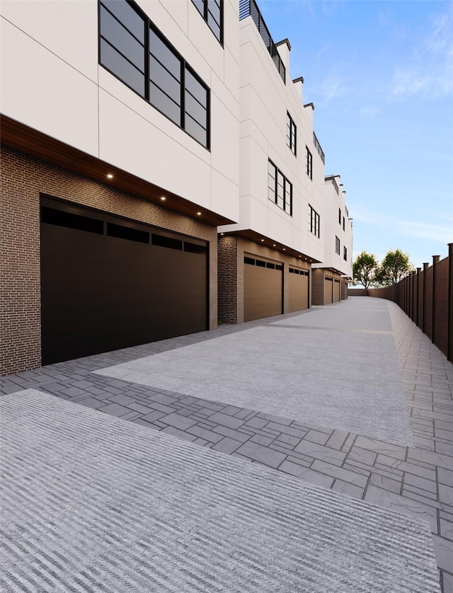 view of home's exterior with fence and stucco siding