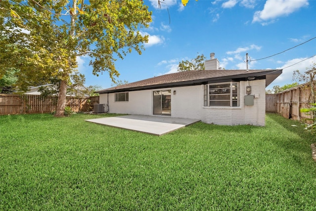 back of house with a patio, cooling unit, a fenced backyard, brick siding, and a yard