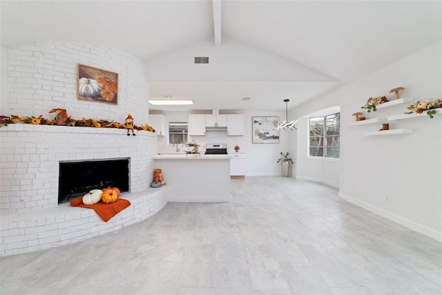 unfurnished living room featuring lofted ceiling with beams, a brick fireplace, baseboards, and visible vents