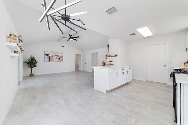 kitchen featuring visible vents, ceiling fan, light countertops, white cabinetry, and gas stove