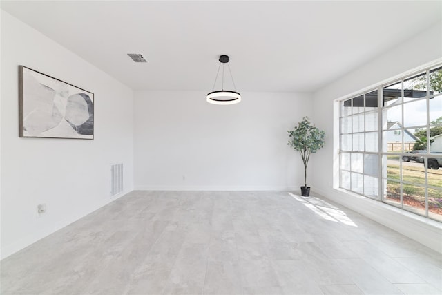 empty room featuring visible vents and baseboards