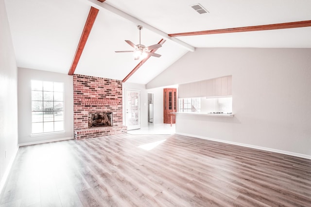 20650 S Hillcrest Dr, Porter, TX 77365 - unfurnished living room featuring beam ceiling, wood finished floors, ceiling fan, baseboards, and high vaulted ceiling