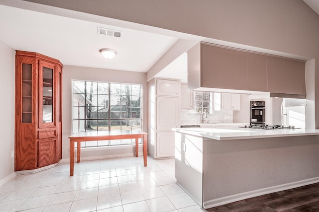 20650 S Hillcrest Dr, Porter, TX 77365 - kitchen featuring oven, light countertops, stainless steel gas cooktop, baseboards, and decorative backsplash