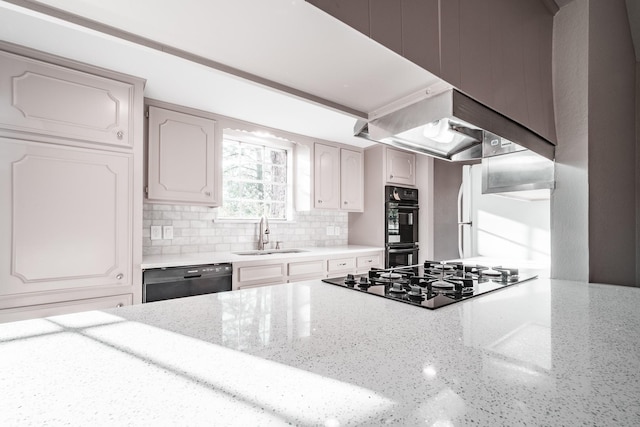 20650 S Hillcrest Dr, Porter, TX 77365 - kitchen featuring black appliances, a sink, backsplash, light stone countertops, and wall chimney exhaust hood
