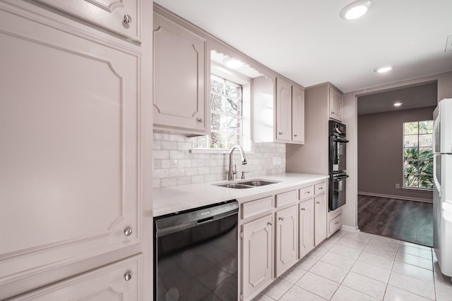 20650 S Hillcrest Dr, Porter, TX 77365 - kitchen with black appliances, a sink, light countertops, light tile patterned floors, and tasteful backsplash