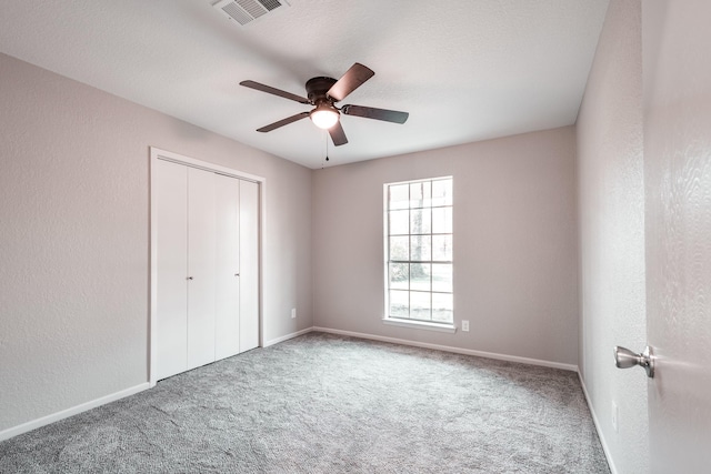 20650 S Hillcrest Dr, Porter, TX 77365 - unfurnished bedroom with carpet flooring, a closet, baseboards, and a textured wall