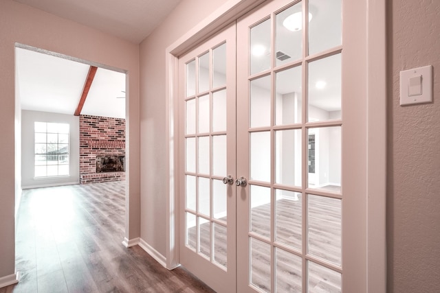 20650 S Hillcrest Dr, Porter, TX 77365 - corridor featuring dark wood-style flooring, a textured wall, french doors, and baseboards