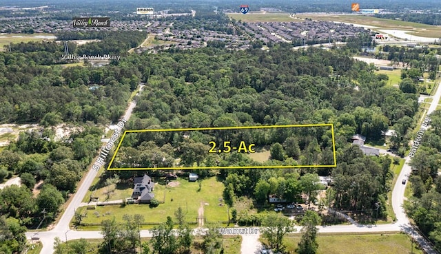 20650 S Hillcrest Dr, Porter, TX 77365 - aerial view of property and surrounding area with property parcel outlined and a heavily wooded area