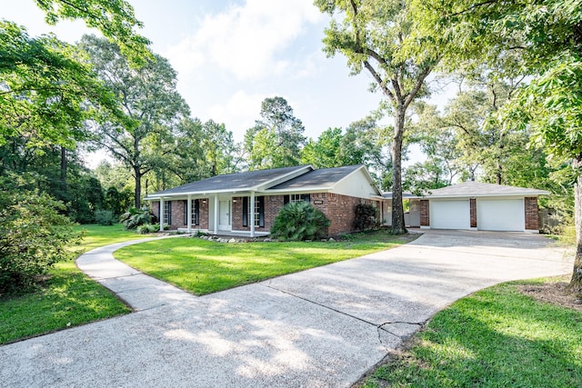 20650 S Hillcrest Dr, Porter, TX 77365 - single story home featuring brick siding, driveway, a front lawn, and an outdoor structure