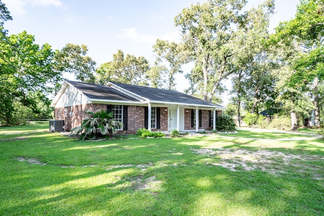20650 S Hillcrest Dr, Porter, TX 77365 - ranch-style house featuring brick siding, a front lawn, a porch, and central AC
