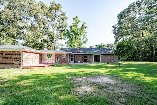 20650 S Hillcrest Dr, Porter, TX 77365 - rear view of property featuring brick siding, a yard, a chimney, and a patio area