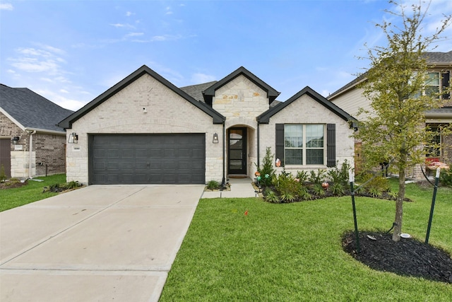 french provincial home featuring a front yard, concrete driveway, brick siding, and an attached garage