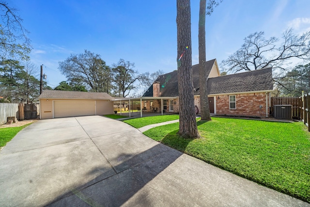 view of front of house with brick siding, fence, a front lawn, and central AC unit