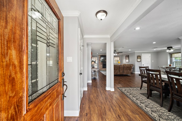 entryway with dark wood-style floors, ornamental molding, baseboards, and a ceiling fan