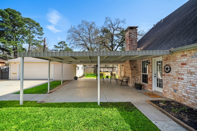 view of patio with a garage and fence