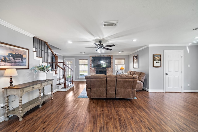 living area featuring stairs, visible vents, a fireplace, and dark wood-type flooring