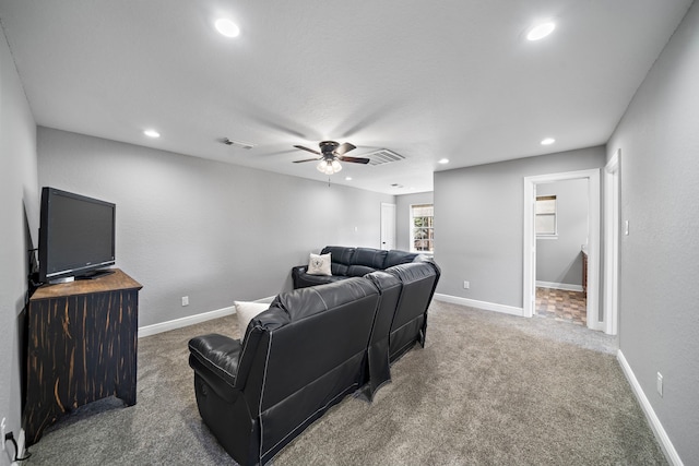 cinema room with carpet floors, recessed lighting, visible vents, and baseboards