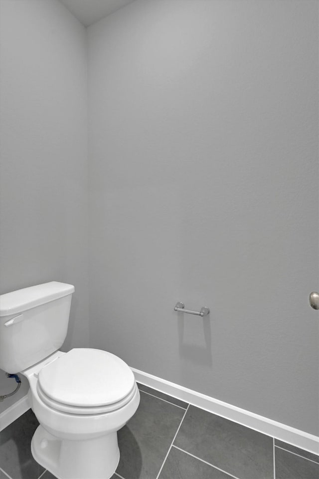 715 Whispering Winds Dr, Beasley, TX 77417 - bathroom featuring tile patterned flooring, toilet, and baseboards