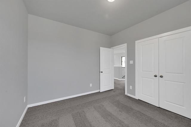 715 Whispering Winds Dr, Beasley, TX 77417 - unfurnished bedroom featuring dark colored carpet, baseboards, and a closet
