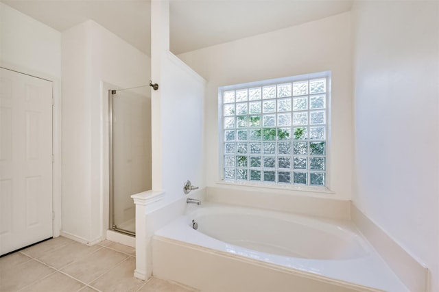 full bathroom with tile patterned flooring, a garden tub, and a shower stall