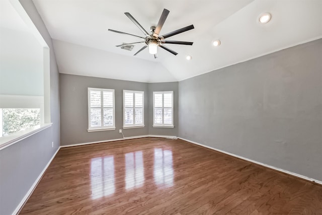 unfurnished room featuring lofted ceiling, visible vents, ceiling fan, wood finished floors, and baseboards