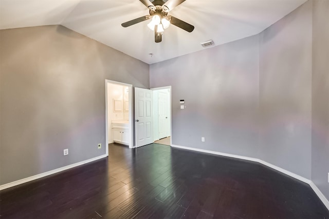 spare room featuring dark wood-style floors, ceiling fan, and baseboards