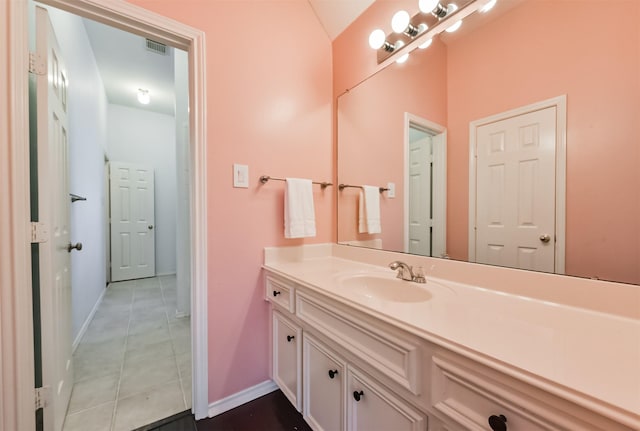 bathroom featuring baseboards, vanity, visible vents, and tile patterned floors