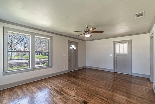 entrance foyer featuring baseboards, visible vents, ceiling fan, ornamental molding, and dark wood-type flooring