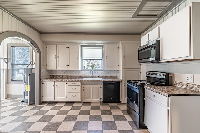 kitchen with stainless steel appliances, a sink, white cabinets, water heater, and light floors