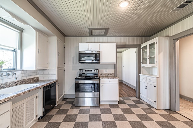 kitchen featuring stainless steel appliances, glass insert cabinets, a sink, and white cabinetry