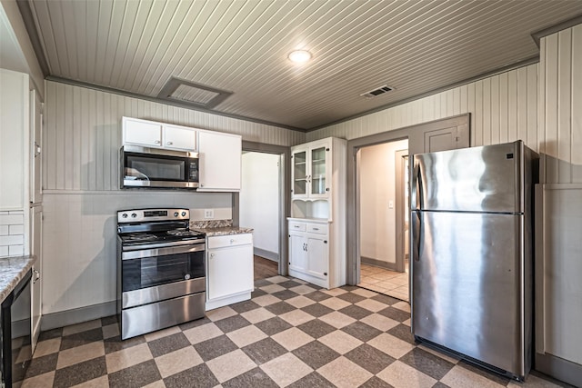 kitchen featuring visible vents, glass insert cabinets, appliances with stainless steel finishes, tile patterned floors, and white cabinetry