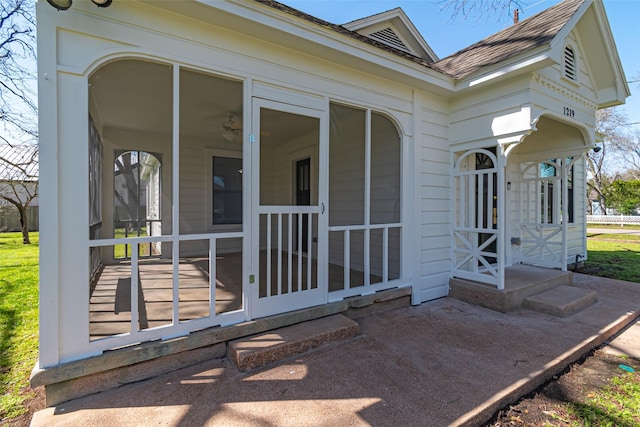 doorway to property with roof with shingles