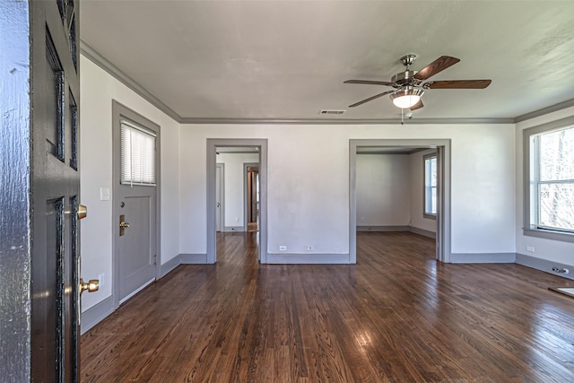 unfurnished bedroom featuring baseboards, dark wood-style flooring, a ceiling fan, and crown molding