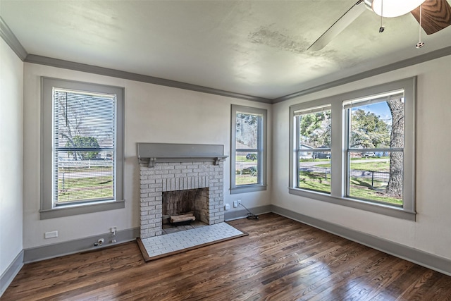 unfurnished living room featuring baseboards, a fireplace, wood finished floors, and crown molding