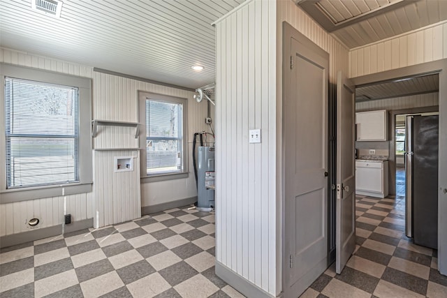 kitchen with plenty of natural light, electric water heater, and tile patterned floors