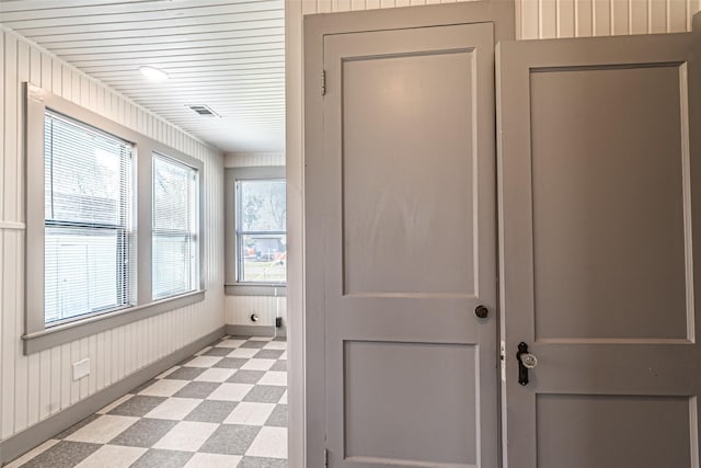 interior space featuring wood walls and tile patterned floors