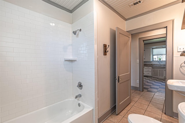 bathroom featuring visible vents, toilet, tub / shower combination, a sink, and tile patterned flooring