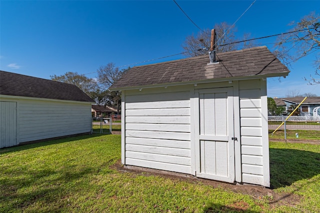 view of shed featuring fence