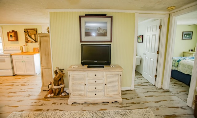 hallway with ornamental molding and light wood-style flooring